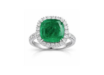Ring with a green gemstone and diamond accents on a white background