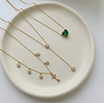 Gold necklaces with key and heart pendant